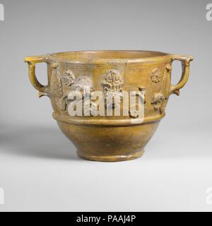 Fragmentary terracotta scyphus (drinking cup). Culture: Roman. Dimensions: H. 6 1/2 in. (16.5 cm); width with handles 10 5/8 in. (27 cm). Date: 1st half of 1st century A.D..  The sides of this very large drinking cup are decorated with various appliqués, including heads, sea monsters, rosettes, and leaves. Museum: Metropolitan Museum of Art, New York, USA. Stock Photo