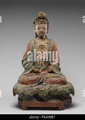 Figure seated on lotiform base. Culture: China. Dimensions: a. H. 22 3/4 in. (57.8 cm); W. 15 3/4 in. (40 cm); D. 10 1/2 in. (26.7 cm)  b. H. 8 1/4 in. (21 cm); W. 19 in. (48.3 cm); D. 12 3/4 in. (32.4 cm). Museum: Metropolitan Museum of Art, New York, USA. Stock Photo