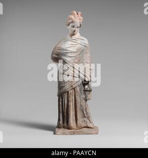 Terracotta draped woman. Culture: Greek, Boeotian. Dimensions: H. 7 3/4in. (19.6 cm). Date: 3rd century B.C..  Enveloped in himation; standing and draped. Museum: Metropolitan Museum of Art, New York, USA. Stock Photo