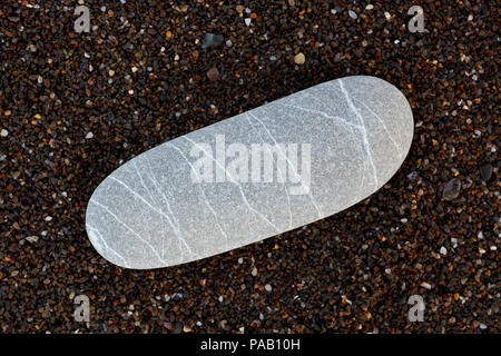 abstract with dry round reeble stones on dark brown sand background Stock Photo