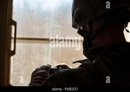 A military policeman with Bravo Company, 2nd Law Enforcement Battalion, photographs evidence during Tactical Site Exploitation training at Camp Lejeune, North Carolina. The photographs ensure Marines can continue analyzing materials even if the physical evidence is removed. The exercise trains personnel in forensic documentation, evidence preservation, operational readiness, and investigative procedures. Stock Photo