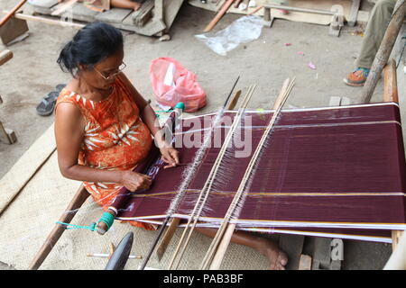 women engaged in traditional weaving at the indonesian island of sumatra. Stock Photo