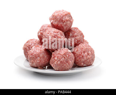 Heap of fresh raw meatballs on plate isolated on white Stock Photo