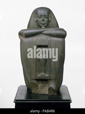 Naophorous Block Statue of a Governor of Sais, Psamtik[seneb]. Dimensions: H. 31 × W. 16.6 × D. 17.3 cm, 12 kg (12 3/16 × 6 9/16 × 6 13/16 in., 26.5 lb.). Dynasty: Dynasty 26. Date: 664-610 B.C..  This statue represents a governor of the Saite nome (district) in the western Nile Delta, and was intended for a temple in Sais, its capital city. The temple, called the 'House of the Bee,' was dedicated to Osiris, who is represented standing in a shrine on the front of the statue. Museum: Metropolitan Museum of Art, New York, USA. Stock Photo