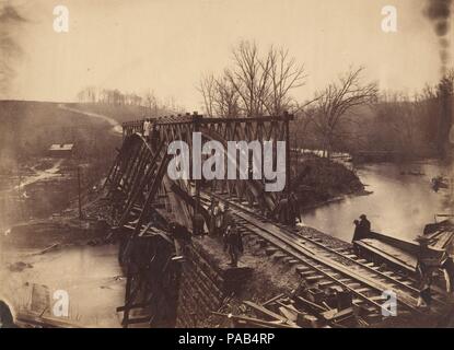 Part of Construction Corps Building New Military Truss Bridge Across Bull Run. Artist: Egbert Guy Fowx (American, born 1821). Dimensions: Image: 15 x 20.6 cm (5 7/8 x 8 1/8 in.)  Mount: 19.9 x 25 cm (7 13/16 x 9 13/16 in.). Date: April 1863.  In 1861, at the outbreak of the Civil War, Fowx left his portrait studio in Baltimore, Maryland, and joined Mathew Brady's corps of photo-graphers documenting the War Between the States. In 1863, along with many other cameramen, he would leave Brady's employ to work exclusively for Alexander Gardner, Brady's former studio manager. This photograph is typic Stock Photo