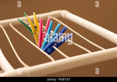 Isolated colored clothespins on the clotheshorse (Pesaro, Italy, Europe) Stock Photo