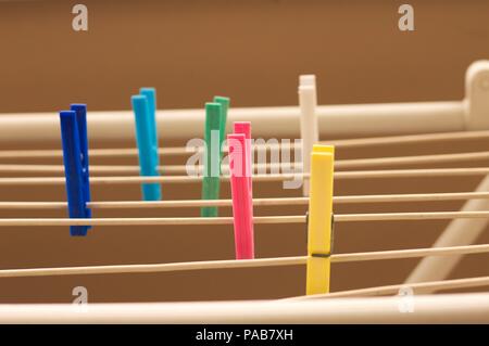Isolated colored clothespins on the clotheshorse (Pesaro, Italy, Europe) Stock Photo
