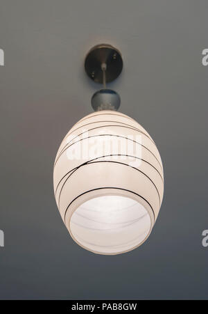 Closeup of hanging electric ceiling light with striped lamp shade Stock Photo