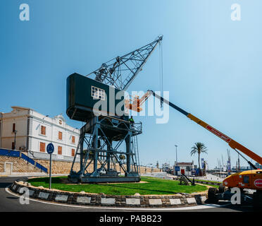 Tarragona, Spain - July 11, 2018: Giant port crane on a roundabout at Port Esportiu de Tarragona, a popular marina Stock Photo