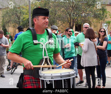 A marching Irish band is featured at the St. Patrick's Day Block Festival in Corpus Christi, Texas. Here a man plays the drum in Irish garb. Stock Photo