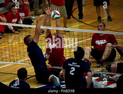 SPRINGS, Colo. (May 12, 2013) Members of team Navy Coast Guard and team Marine Corps battle at the net during a seated volleyball match at the 2013 Warrior Games. More than 200 wounded, ill and injured service members and veterans, as well as an international team representing the United Kingdom, will compete at the U.S. Olympic Training Center and U.S. Air Force Academy. The military service with the most medals will win the Chairman's Cup. Stock Photo
