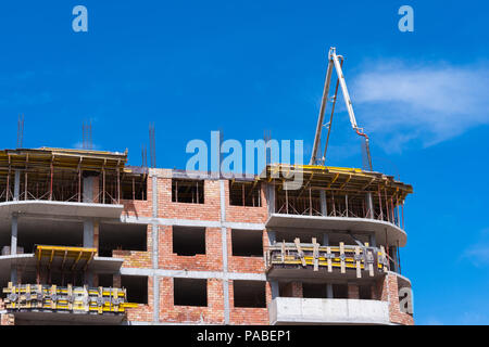 Construction building works with automobile concrete pump. Stock Photo