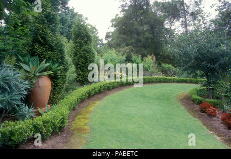 Large garden in the Blue Mountains region of Sydney, New South Wales, Australia featuring low hedging, lawn and assorted trees, bushes and shrub. Stock Photo