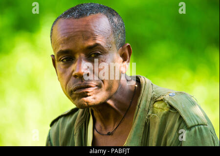 OMO, ETHIOPIA - SEPTEMBER 20, 2011: Unidentified Ethiopian man portrait in khaki shirt. People in Ethiopia suffer of poverty due to the unstable situa Stock Photo