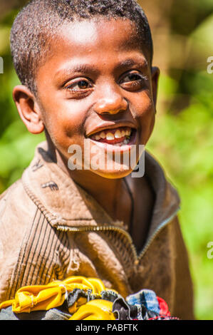 OMO, ETHIOPIA - SEPTEMBER 20, 2011: Unidentified Ethiopian boy smiles. People in Ethiopia suffer of poverty due to the unstable situation Stock Photo