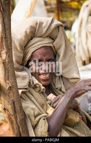 OMO, ETHIOPIA - SEPTEMBER 20, 2011: Unidentified Ethiopian smiling sympatc woman smiles for the camera wearing many tissues. People in Ethiopia suffer Stock Photo