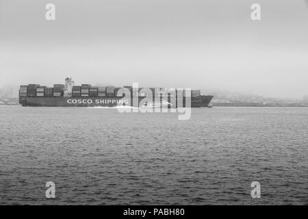 Black And White Photo Of The COSCO SHIPPING Container Ship, CSCL BOHAI SEA Departing, Oakland, San Francisco In The Early Morning Mist. Stock Photo