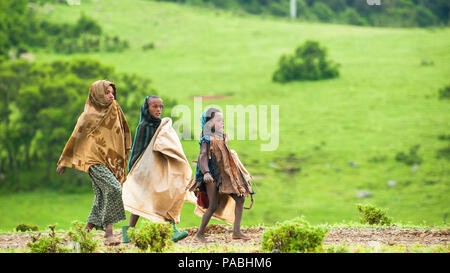 AKSUM, ETHIOPIA - SEPTEMBER 22, 2011: Unidentified Ethiopian children walk with the natural background. People in Ethiopia suffer of poverty due to th Stock Photo