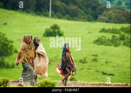 AKSUM, ETHIOPIA - SEPTEMBER 22, 2011: Unidentified Ethiopian children walk with the natural background. People in Ethiopia suffer of poverty due to th Stock Photo