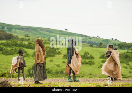 AKSUM, ETHIOPIA - SEPTEMBER 22, 2011: Unidentified Ethiopian children walk with the natural background. People in Ethiopia suffer of poverty due to th Stock Photo