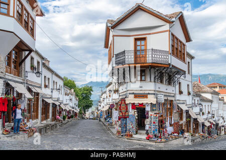 Ottoman architecture and souvenier shops on the main street in the bazaar area of Gjirokastra in southern Albania Stock Photo