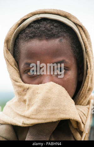 OMO VALLEY, ETHIOPIA - SEP 22, 2011: Unidentified Ethiopian little boy wearing old clothes in Ethiopia, Sep.22, 2011. Children in Ethiopia suffer of p Stock Photo