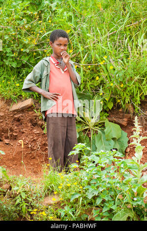 AKSUM, ETHIOPIA - SEPTEMBER 22, 2011: Unidentified Ethiopian boy stays with the beautiful nature. People in Ethiopia suffer of poverty due to the unst Stock Photo