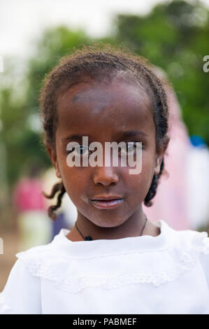 AKSUM, ETHIOPIA - SEP 27, 2011: Portrait of an unidentified Ethiopian child wearing old clothes in Ethiopia, Sep.27, 2011. Children in Ethiopia suffer Stock Photo