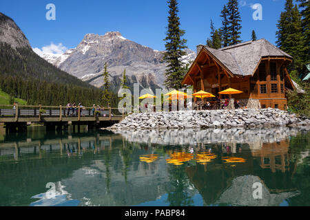 Emerald Lake, Yoho National Park, British Columbia, Canada - June 17, 2018: People are enjoying their holiday on a patio by the cabin. Stock Photo