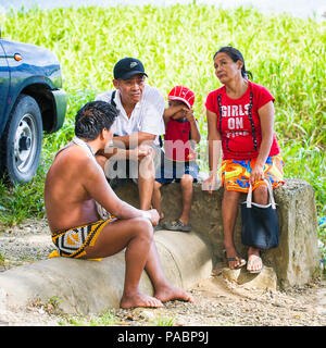 EMBERA VILLAGE, PANAMA, JANUARY 9, 2012: Unidentified Panamanaian Indian speaks to the tourists in Panama, Jan 9, 2012. Indian reservation is the way  Stock Photo