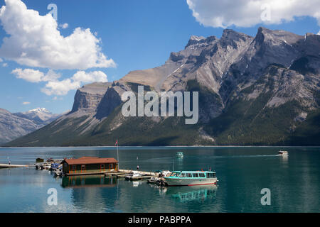 Banff, Alberta, Canada - June 20, 2018: Boats at the dock with a beautiful Canadian Mountain Landscape in the background. Stock Photo