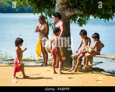 EMBERA VILLAGE, PANAMA, JANUARY 9, 2012: Unidentified native Indian family make music for tourists  in Panama, Jan 9, 2012. Indian reservation is the  Stock Photo