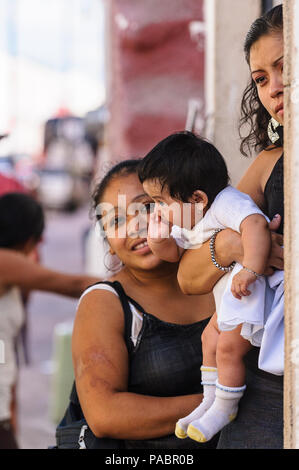 MEXICO CITY, MEXICO - DEC 29, 2011: Unidentified Mexicanlittle baby and his mother.  60% of Mexican people belong to the Mestizo ethnic group Stock Photo