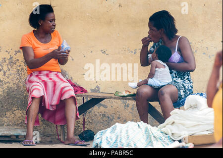 GHANA - MARCH 2, 2012: Two unindentified Ghanaian women discuss something in Ghana, on March 2nd, 2012. People in Ghana suffer from poverty due to the Stock Photo