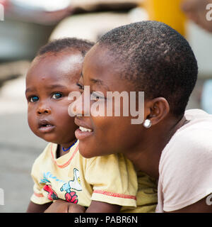 GHANA - MARCH 2, 2012: Portrait of an unindentified Ghanaian mother and her childin Ghana, on March 2nd, 2012. People in Ghana suffer from poverty due Stock Photo