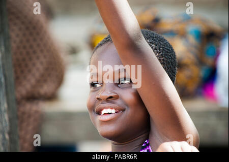 GHANA - MARCH 2, 2012: Portrait of an unindentified Ghanaian smiling girl in Ghana, on March 2nd, 2012. People in Ghana suffer from poverty due to the Stock Photo