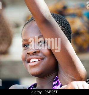 GHANA - MARCH 2, 2012: Portrait of an unindentified Ghanaian smiling girl in Ghana, on March 2nd, 2012. People in Ghana suffer from poverty due to the Stock Photo