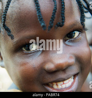 GHANA - MARCH 2, 2012: Portrait of an unindentified Ghanaian smiling girl in Ghana, on March 2nd, 2012. People in Ghana suffer from poverty due to the Stock Photo