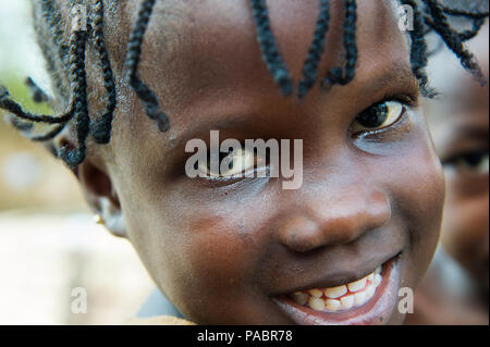 GHANA - MARCH 2, 2012: Portrait of an unindentified Ghanaian smiling girl in Ghana, on March 2nd, 2012. People in Ghana suffer from poverty due to the Stock Photo