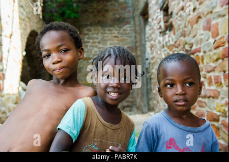 GHANA - MARCH 2, 2012: Three unindentified Ghanaian children smile for the camera in Ghana, on March 2nd, 2012. People in Ghana suffer from poverty du Stock Photo