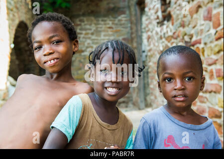 GHANA - MARCH 2, 2012: Three unindentified Ghanaian children smile for the camera in Ghana, on March 2nd, 2012. People in Ghana suffer from poverty du Stock Photo