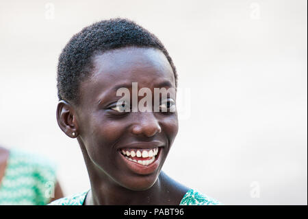 ACCRA, GHANA - MARCH 2, 2012: Unidentified Ghanaian girl smiles. People of Ghana suffer of poverty due to the unstable economic situation Stock Photo