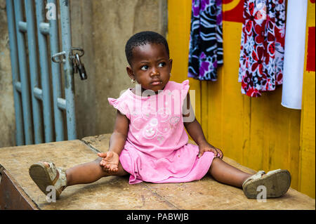 ACCRA, GHANA - MARCH 4, 2012: Unidentified Ghanaian beautiful girl with earings in the street in Ghana. Children of Ghana suffer of poverty due to the Stock Photo