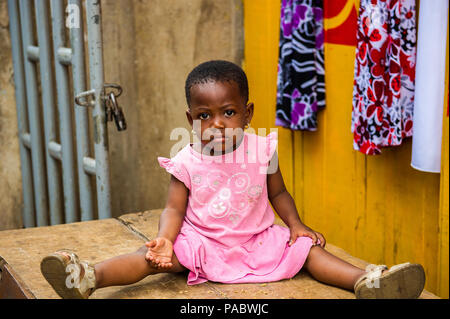 ACCRA, GHANA - MARCH 4, 2012: Unidentified Ghanaian beautiful girl with earings in the street in Ghana. Children of Ghana suffer of poverty due to the Stock Photo