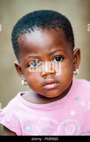 ACCRA, GHANA - MARCH 4, 2012: Unidentified Ghanaian beautiful girl with earings in the street in Ghana. Children of Ghana suffer of poverty due to the Stock Photo