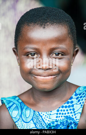 ACCRA, GHANA - MARCH 4, 2012: Unidentified Ghanaian girl portrait in Ghana. People of Ghana suffer of poverty due to the unstable economic situation Stock Photo