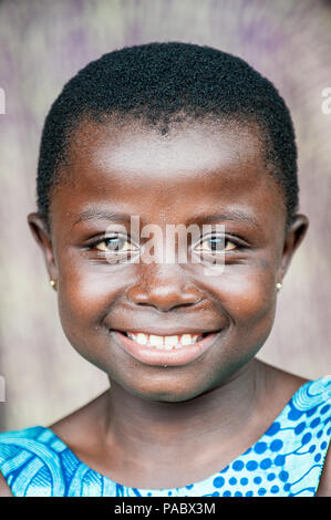 ACCRA, GHANA - MARCH 4, 2012: Unidentified Ghanaian girl portrait in Ghana. People of Ghana suffer of poverty due to the unstable economic situation Stock Photo