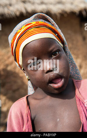 ACCRA, GHANA - MARCH 6, 2012: Unidentified Ghanaian beautiful girl portrait in the street in Ghana. Children of Ghana suffer of poverty due to the uns Stock Photo