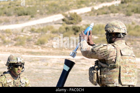 U.S. Army Sgt. Scott Dario, left, observes as PV2 Bryan Philip, right, both mortarmen assigned to 1st Battalion, 503rd Infantry Regiment, 173rd Airborne Brigade, loads an M252 81mm Medium Weight Mortar System during Exercise Sky Soldier 16, March 4, 2016, at Chinchilla training area in Spain. The 173rd Airborne Brigade is the U.S. Army’s Contingency Response Force in Europe, providing rapidly deploying forces to the U.S. Army Europe, Africa and Central Command Areas of Responsibility within 18 hours. The brigade routinely trains alongside NATO allies and partners to build stronger relationship Stock Photo