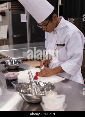 Pfc. Tyquanda Dennis, with the 275th Quartermaster Company, Fort Pickett, Va., cuts strawberries for her entry during the Armed Forces Chef of the Year competition during the 41st Annual Military Culinary Arts Competitive Training Event at the Joint Culinary Center of Excellence, March 6, 2016, at Fort Lee, Va. Dennis, who has been on the U.S. Army Reserve Culinary Arts Team for only three days, scored a bronze medal in her first competition. (U.S. Army photo by Timothy L. Hale/Released) Stock Photo